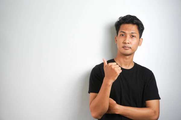 Portrait Happy Young Man Black Shirt Pointing Fingers Away Copy — Stock Photo, Image
