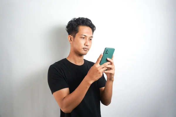 Asian Man Seriously Concentrated Smartphone Isolated White Background — Photo