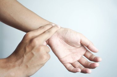A doctor is checking radial pulse of the patient that has palpitation. vital sign, medical, healthcare, hospital, physical examination, check up concept