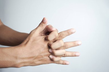 Finger knuckle cracking on the white background, addicted, addictive.