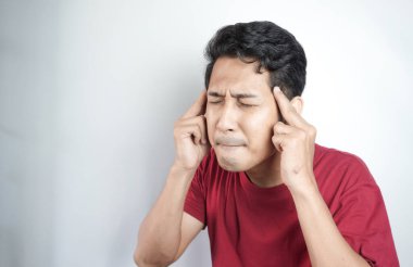 Man with headache rubbing forehead