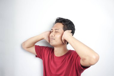 unhappy man closing his ears by hands