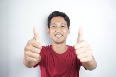 asian man giving thumbs up. pose of Indonesian man giving two thumbs up. portrait of asian man on white background isolated. symbol of good, top, best, champion, satisfied, and proud