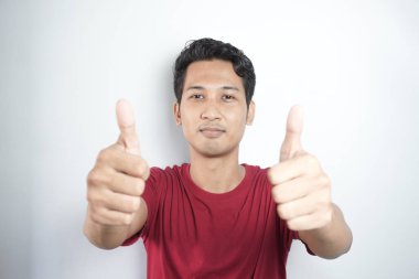 asian man giving thumbs up. pose of Indonesian man giving two thumbs up. portrait of asian man on white background isolated. symbol of good, top, best, champion, satisfied, and proud