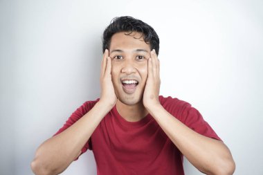 Emotionally frightened black haired man, seen with a frightened expression upon seeing something horrific ahead, looks nervously at the camera, showing phobia. Human reactions and emotions