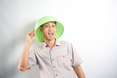 handsome asian man acting or posing silly with serving hood
