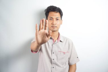 Man over isolated white background making stop gesture with her hand