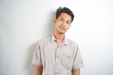 Portrait of attractive confident Asian man head with big smile looking at camera. Posing in a casual style.