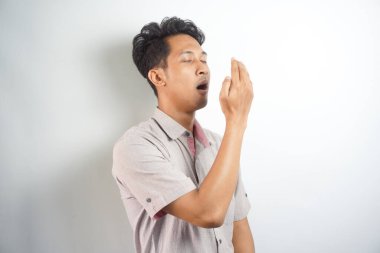 Male checking his breath with the hand. Bad breath. Halitosis concept.
