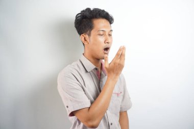 Male checking his breath with the hand. Bad breath. Halitosis concept.