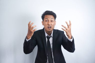 Angry man gesturing angrily raising hands and shouting loudly expressing anger after quarrel with boss or employee in suit isolated over white background. Feel my anger