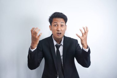 Angry man gesturing angrily raising hands and shouting loudly expressing anger after quarrel with boss or employee in suit isolated over white background. Feel my anger