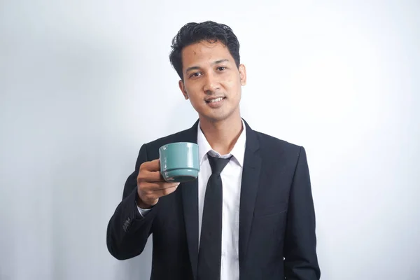 Young Business Man Drinking a Cup of Coffee or Tea
