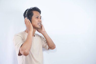 Peaceful positive modern man have black wireless headset listen music enjoy song melody close eyes feel pleasure wear casual style clothes isolated over white color background