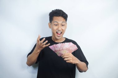 Şok olmuş ve yakışıklı Asyalı bir adamın beyaz duvar arkasında izole edilmiş bir şekilde poz verişi.