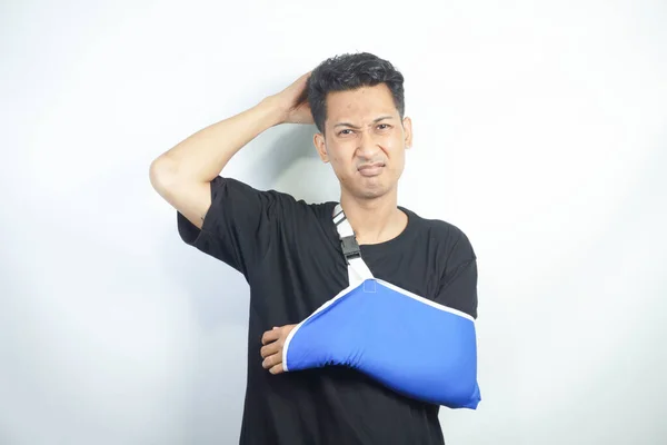 young Asian man with pain and broken hand wearing an arm brace, series