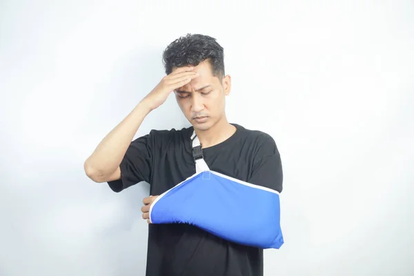 stock image young Asian man with pain and broken hand wearing an arm brace, series