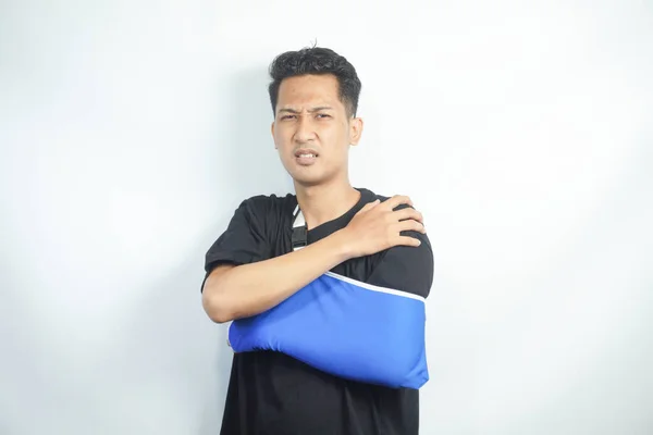 Male in arm sling suffering pain in shoulder, result of work trauma, orthopedics