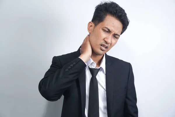 asian young man wearing suit stressed unhappy handsome young man with severe neck pain