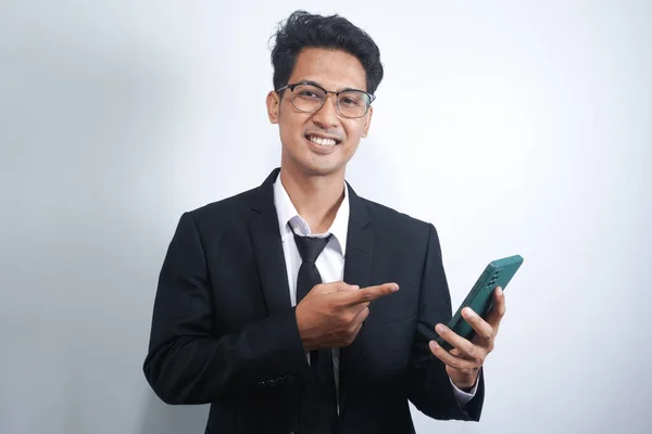 Portrait Happy Asian Young Man Wearing Suit While Pointing Mobile — Stockfoto