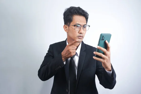 Anger mobile phone mad emotion expressing partner internet people person concept. Portrait of disappointed mad confused with open mouth financier with phone in hand isolated on white