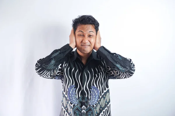 Asian Man Wearing Batik Shirt Covering His Ears Both Hands — Stock Photo, Image