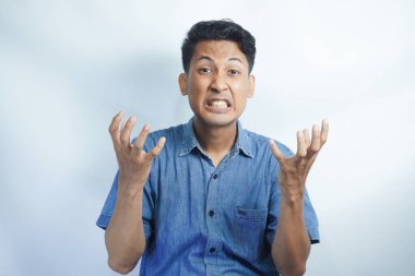 Annoyed and angry man raising hands and clench teeth outraged, stare pissed-off at camera, going to kill someone, standing on white background.