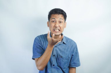 Annoyed and angry man raising hands and clench teeth outraged, stare pissed-off at camera, going to kill someone, standing on white background.