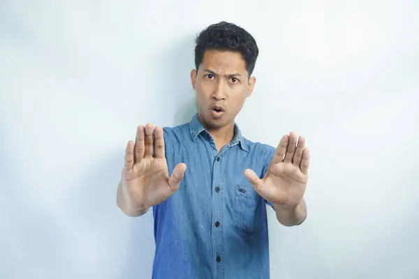 stock image Attractive young asian man on isolated white background scared and terrified with frightened expression stop gesturing with hands, screaming in shock. Panic concept.