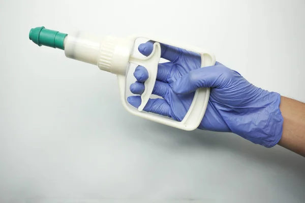 holding cupping pump and wearing medical gloves isolated on white
