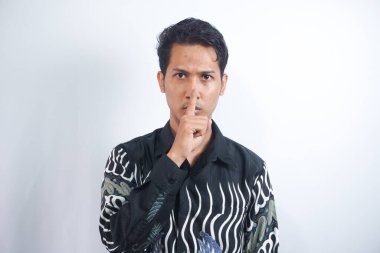 Yakından bakınca, beyaz arka planda dikilirken işaret parmağıyla sessiz hareket eden yakışıklı bir adamın portresi. Bence bunu bir sır olarak saklamalıyız.