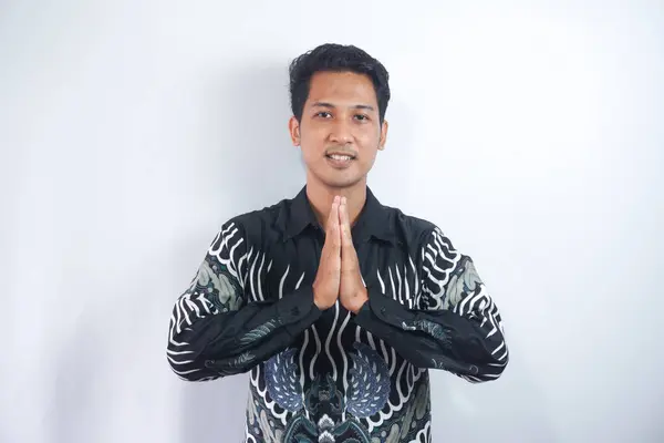 Smiling Young Asian Man Wearing Batik Shirt Gesturing Traditional Greeting — Stok Foto