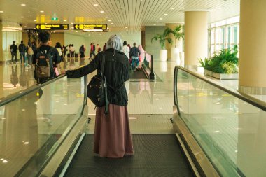 people passing through a corridor at the airport clipart