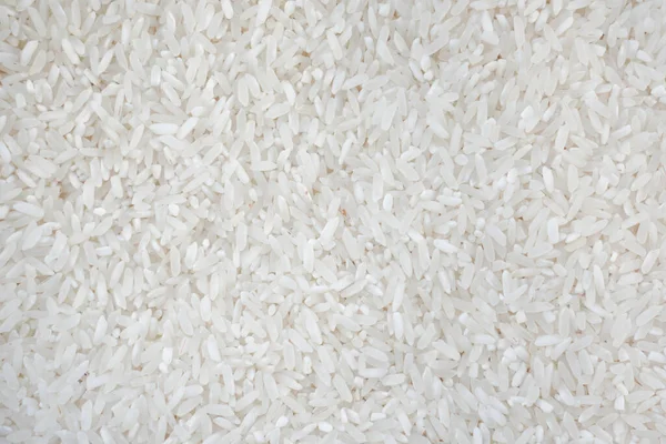 Top view of white rice seed texture background. Organic, natural long rice grain, food for healthy. Agriculture of culture asian. Flay lay