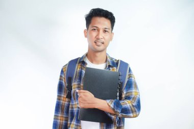 Sırt çantalı mutlu Asyalı öğrenciler okula yalnız beyaz arka planda kitap taşıyorlar. Lise üniversite konsepti eğitimi