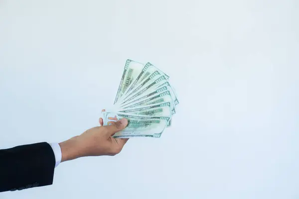 Para değişimi. Açık beyaz arka planda dolar banknotları tutan adam, üst görünüm
