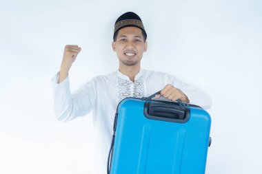 Moslem Asian man carrying suitcase with excited expression clipart