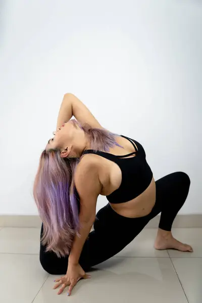 beautiful young woman doing stretching exercises on white background. concept of fitness and lifestyle.