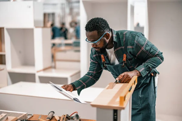Carpenters get order via digital device , analyze blueprint, measure, install, combine, and secure manufactured furniture's components and fixtures. Verifying the quality, and preparing for shipment.