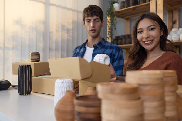 Vase brand owners process online orders, pick product form shelf, photograph, wrap, pack label and prepare for shipping to customers. Giving delivery timeline. Routine work of e-commerce entrepreneur