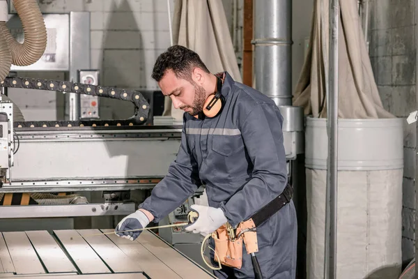 Wood turners measure and calculate the right size of workpiece dimension using hand and power tools. Cut, shape, rotate, smooth, and balance wood fixtures based on measurements and requirements.