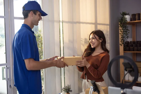 stock image Female vase seller processes orders, including delivery payments, with smartphone and quick response code before sending items to customers. Small business owner work and coordinate with carrier.