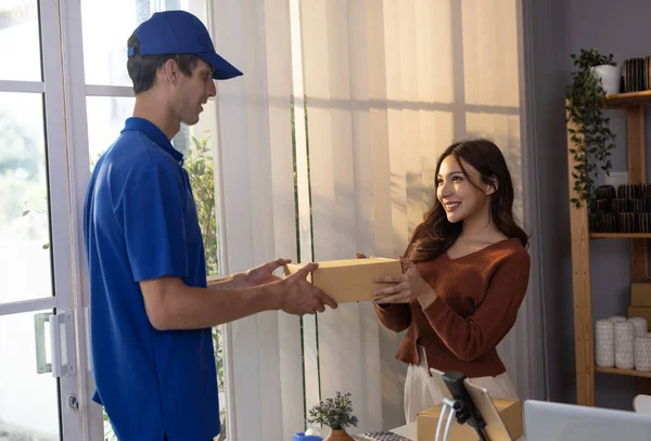 Stock image Female vase seller processes orders, including delivery payments, with smartphone and quick response code before sending items to customers. Small business owner work and coordinate with carrier.