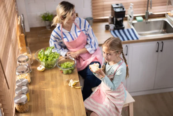 stock image Multi-generational family members explore new and tasteful recipes on a tablet, make healthy food choices, cook, and enjoy meals together. Family gatherings help renew and strengthen relationships.