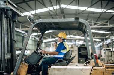 Folklift operatörü, folklörleri nakletmeye, dağıtmaya, malları raflara ve paletlere yerleştirmeye yönlendiriyor. Telsiz alıcısı aracılığıyla iş arkadaşları ve yöneticilerle ilgili işletim prosedürlerini güncellemeye devam et.