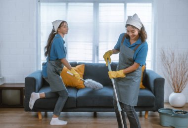 Hevesli ev temizlikçisi kadın çeşitli görevlerde sorumluluk sahibi. Paspas, süpürge, çamaşır makinesi, temizlik malzemeleri, temizlik malzemeleri mobilya, cam, zemin, giysi, bulaşık....