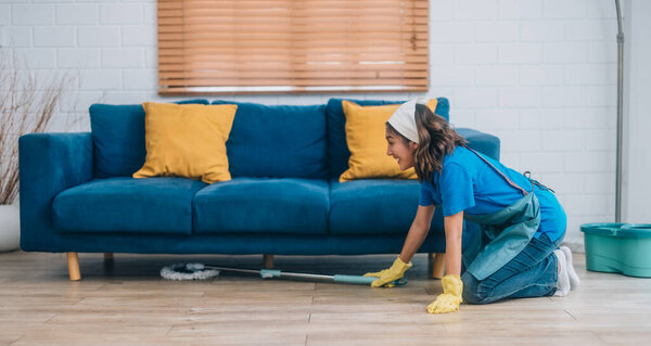 Enthusiastic house cleaning lady do various tasks with responsibility. Using mop, broom, laundry machine, cleaning supplies to wipe, scrub, and dust furniture, glassware, floors, clothes, dishes.