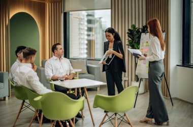 In multicultural workspace, innovative project manager present sustainable solar panel product, fostering collaboration and diversity among colleagues, aiming for efficient, renewable energy solution