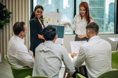 In multicultural workspace, innovative project manager present sustainable solar panel product, fostering collaboration and diversity among colleagues, aiming for efficient, renewable energy solution