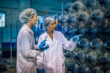 Tecrübeli imalat danışmanı koçları ve kalite kontrol stajyeri. İçme suyu dağıtımının kusursuz ve etkili bir şekilde incelenmesi için envanter, fiziksel standart